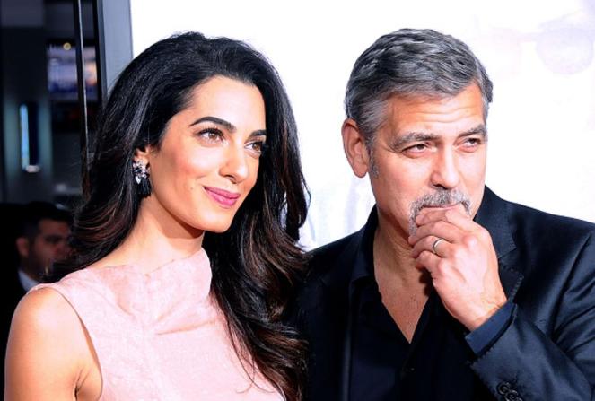 HOLLYWOOD, CA - OCTOBER 26: (L-R) Lawyer Amal Alamuddin Clooney and actor/producer George Clooney arrive at the Premiere of Warner Bros. Pictures' 'Our Brand Is Crisis' at TCL Chinese Theatre on October 26, 2015 in Hollywood, California. (Photo by Barry King/Getty Images)