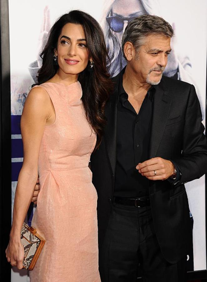 HOLLYWOOD, CA - OCTOBER 26: Amal Clooney and George Clooney attend the premiere of 