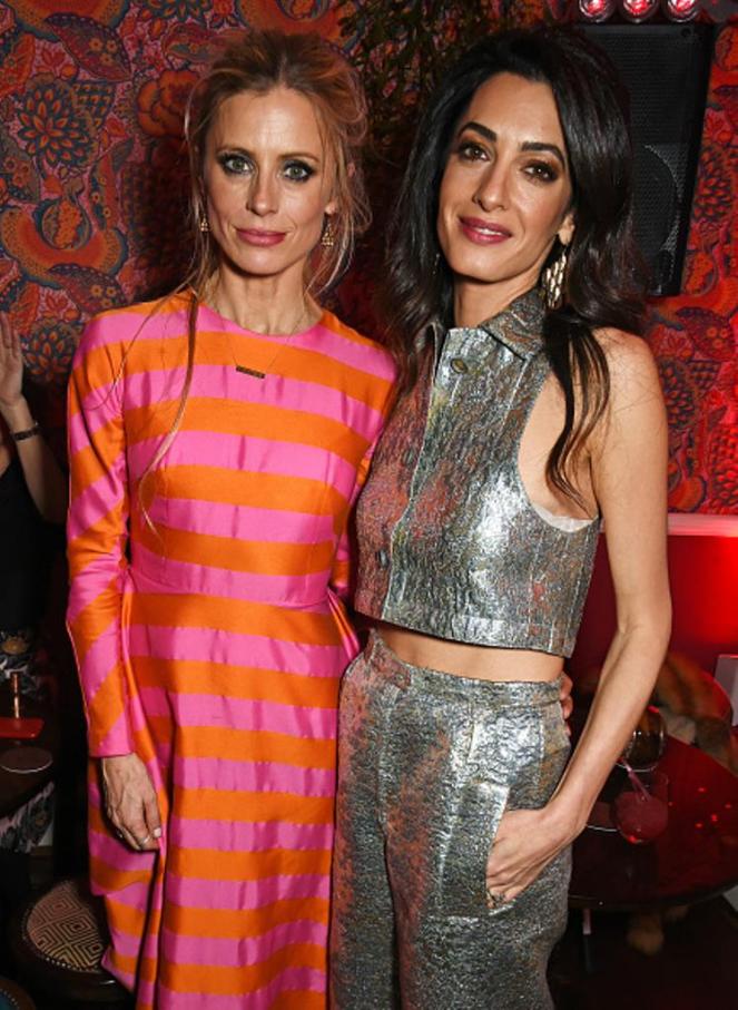 LONDON, ENGLAND - DECEMBER 03: Laura Bailey (L) and Amal Clooney attend Charlotte Tilbury's naughty Christmas party celebrating the launch of Charlotte's new flagship beauty boutique in Covent Garden on December 3, 2015 in London, England. (Photo by David M. Benett/Dave Benett/Getty Images for Charlotte Tilbury)