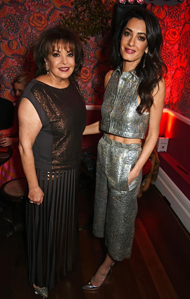 LONDON, ENGLAND - DECEMBER 03: Amal Clooney (R) and mother Baria Alamuddin attend Charlotte Tilbury's naughty Christmas party celebrating the launch of Charlotte's new flagship beauty boutique in Covent Garden on December 3, 2015 in London, England. (Photo by David M. Benett/Dave Benett/Getty Images for Charlotte Tilbury)